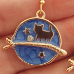 Cute little gold tone kitty star gazing on a limb